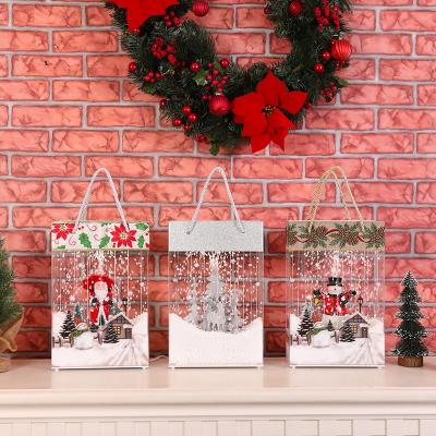 China Snowfall Lighting Musical Regalo Bolsas Navidad Elegante Christmas High End Handbag With Music Usb Power Supply Led Creative Snow Stage Lights for sale