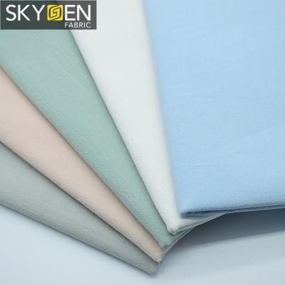 China Skygen Anti-Static Customized Plain Weave Solid Color 137 Gsm Cotton Spandex 40s Stretch Poplin Fabric for sale