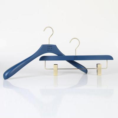 China Eco-friendly Material Custom Blue Matte Painted Wooden Trouser Pants Hanger With Brand Logo Metal Clips for sale