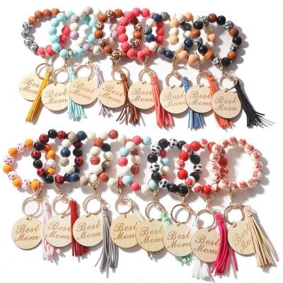 China 2022 wholesale custom wooden leopard with wooden bangle bracelet convenience tassel beads key chain for sale