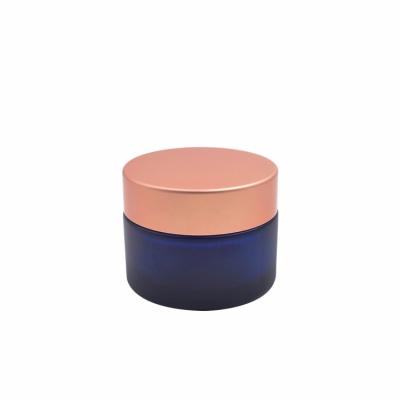 China cosmetic blue 50g big size glass cream jar with rose gold aluminum jar suitable for serum cream for sale