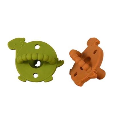 China BPA free baby silicone pacifier suitable for baby's new full silicone dinosaur round head pacifier for sale