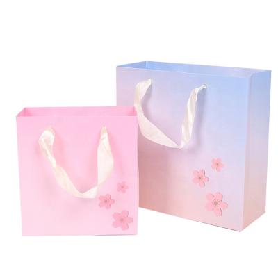 China Fashion Design Gradient Color Satin Ribbon Handle Wedding Gift Recyclable Premium Paper Bag for sale