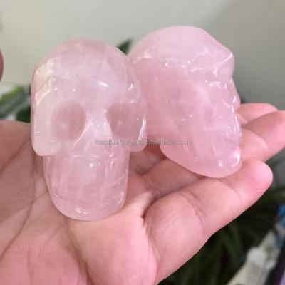 China Wholesale Natural Rose Rose Quartz Crystal Carved Skulls from Europe Healing Reiki Decoration for sale