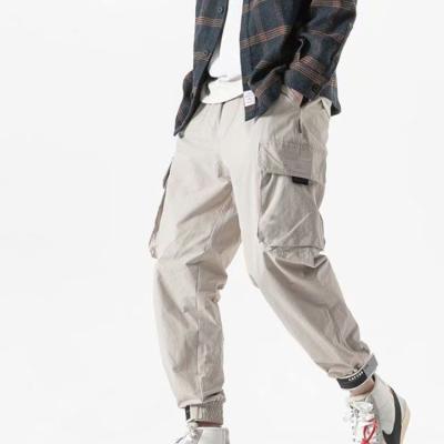 China Wholesale OEM Newest Design Waterproof White With Drawstring Elastic Waist Hip Hop Cargo Jogger Loose Fit Pants For Men for sale