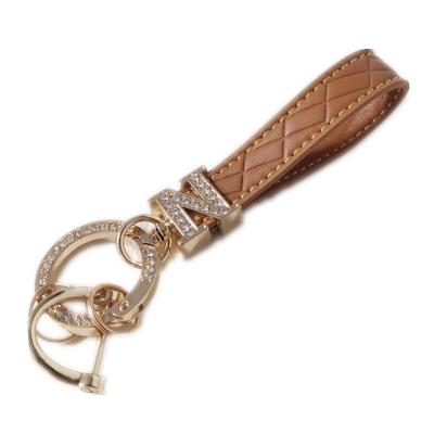 China Leather N letter knitted car keychain PU belt embossed anti-loss keychain Custom color car keychain for sale