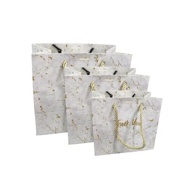 China High Quality Recyclable Custom Logo Gold Foil Stamping Matte Black Paper Bag With Paper Ribbon Handle Bag En for sale