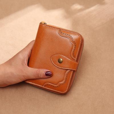 China 2020 anti-theft new fashion clutch bag cavity pattern genuine leather short purses and wallet women handbags for sale