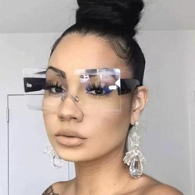 China Fashion sunglasses rimless one-piece sunglasses female street shooting the same style large glass frame fashionable glasses for sale