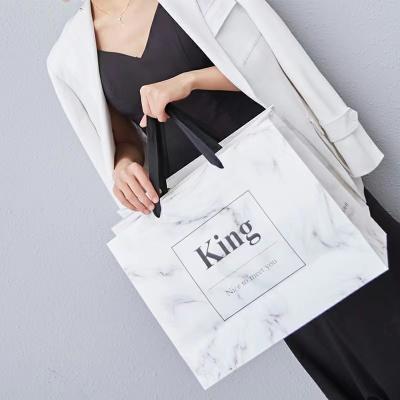 China Recycled Materials Customized Logo Recoverable High Retail Kraft Paper White Garment Paper Bag for sale