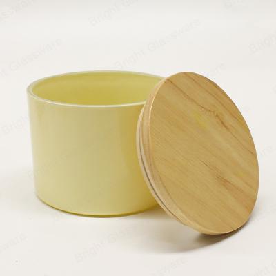 China Custom Cream Yellow 3 Wick Cylinder Color Candle Glass Jar Candle Container With Lid Wood Candle Holder for sale