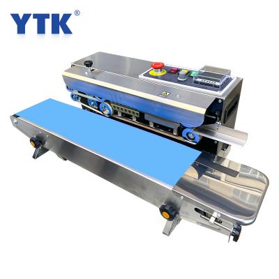 China 220V Food Stainless Steel Heat Machine Food Wrapping Film Bag Automatic Continuous Compound Belt Sealing for sale