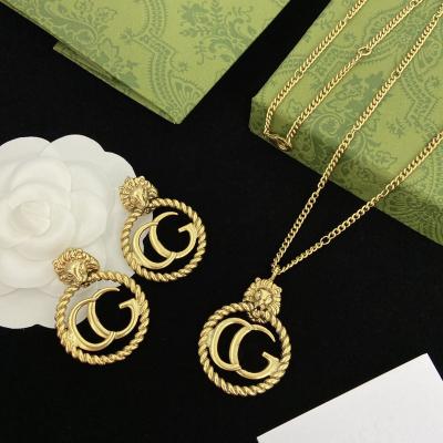 China TRENDY Wholesale fashion pendant necklace earrings women set retro gold plated stainless steel brand jewelry set for sale