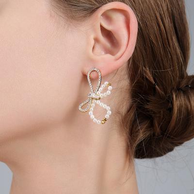 China The 2021 new personality temperament romantic earrings 925 silver needles shape exaggerated bow pearl earrings for sale