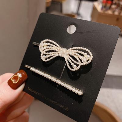 China 2021 fashion new Korean version women's elegant bow pearl hair clip set fashion metal hollow hair clip for sale