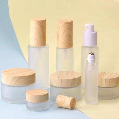 China Personal Care Frosted Glass Cream Jar Lotion Spray Pump Bottle With Wooden Bamboo Lid Cap Skin Care Packaging Set Eco-Friendly for sale