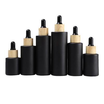 China Easy To Carry In Stock Cosmetic Packaging 30ml Glass Black Essential Oil Dropper Bottle for sale