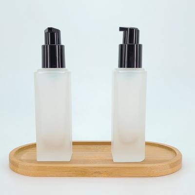 China Personal Care 15ml 30ml Frosted Clear Square Foundation Serum Glass Cosmetic Flat Bottle for sale