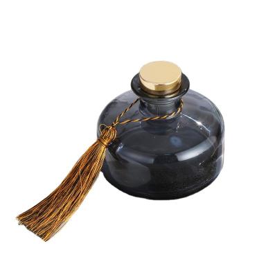 China Luxury New Design Personal Care Round Reed Diffuser Glass Bottle Black 200ml with Reed Diffuser Cap for sale