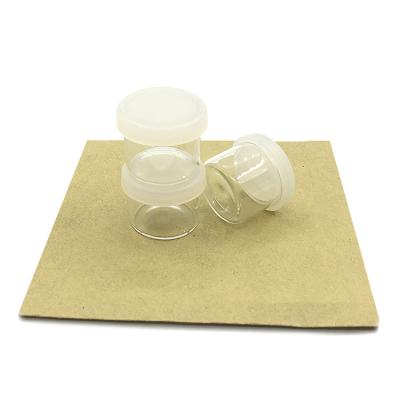 China Bottom Clear Glass Empty 6g Round Lip Balm Jar Glass Bottles With Silicone Cover for sale