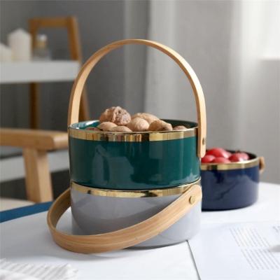 China New Design Gold Rim Food Container Sustainable Ceramic Food Container Snack Fruit Bowl With Wooden Handle for sale