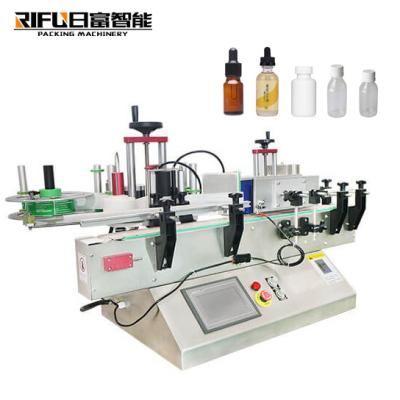 China Food Table Top Small Vial Sticker Automatic Round Bottle Labeling Machine With Conveyor for sale