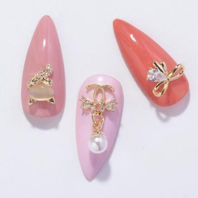 China Nail Accessories Wholesale Mixed Nail Art Designs Rhinestone Nail Beauty Accessories DIY Gold Metal Alloy Nail for sale