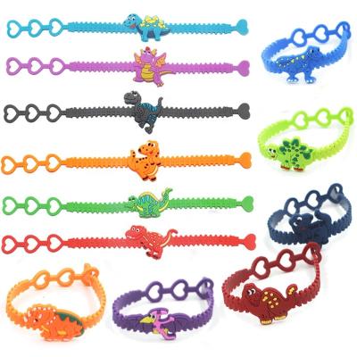 China PVC Cute Dinosaur Rubber Bracelet Ring Baby Shower Birthday Party Decorations Kids Gifts Jungle Party Supplies for sale