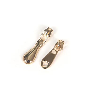 China Durable Logo Metal Zipper Pullers Custom Gold Bag Purse Zipper Puller for sale