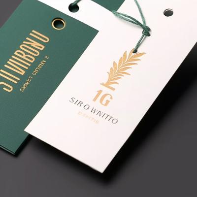 China Hang Tags Black Cardboard Viable Luxury Custom Embossed Garment Tags Clothing Tags Paper Apparel Tag With Logo For Clothing for sale