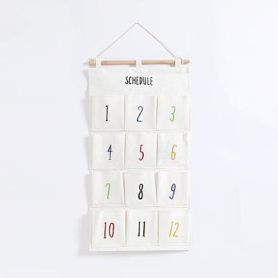 China Sustainable Cotton Storage Bag 12 Canvas Hanging Pockets Behind Doors On Walls Cosmetic Toys Hanging Organizer for sale