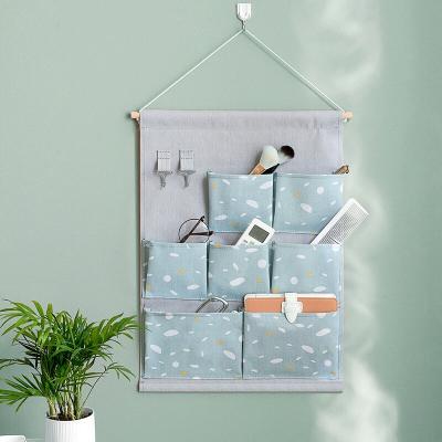 China Sustainable Cotton Canvas 7 Pockets Hanging Wall Hanging Storage Bag Cabinet Grocery Organizers For Room Bathroom for sale