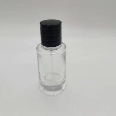 China Personal Care Cylinder 30ml Transparent Empty Glass Perfume Spray Bottle With Pump Cap for sale