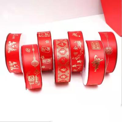 China Recyled Wholesale 25mm Double Face Spot Ribbon Gold Foil Printing Chinese New Year Gift Wrapping Ribbon for sale