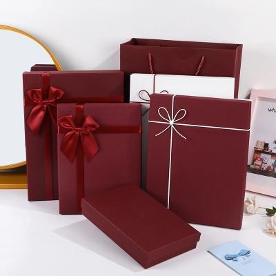 China Recycled Materials Custom books shaped red rigid paper gift box with ribbon for sale