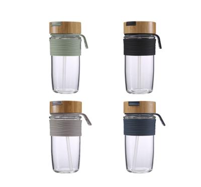 China Viable Customize 600ml Glass Water Bottle With Lid Silicone Pad Sleeve Bamboo Cover for sale