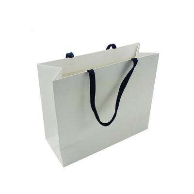 China Luxury Recycled Materials Clothing Paper Tote Bag With Gift Luxury White Kraft Paper Shopping Bag for sale