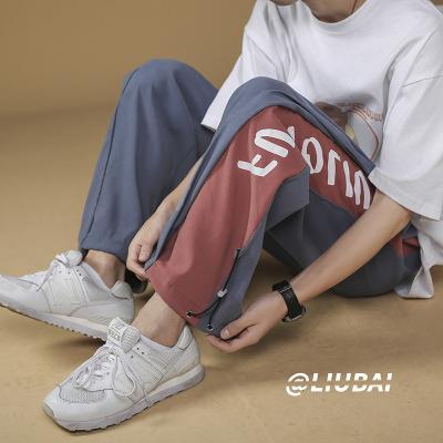 China New men's anti-wrinkle thin running boys student sports Korean Division men's casual pants fashion sweatpants summer loose pants for sale