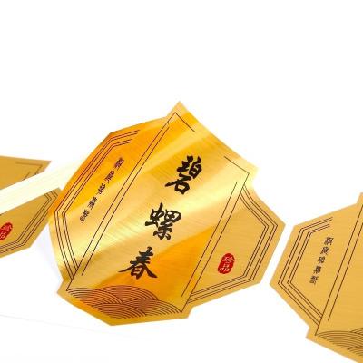 China Tea self-adhesive label waterproof gold luminous logo sticker waterproof drawing printing for sale