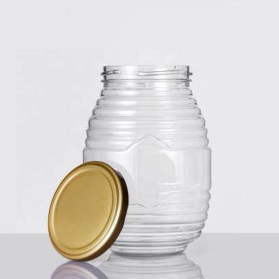 China 1000ml Food Round Cone Ripple Shape Transparent Honey Bottle Food Grade Plastic Package With StainSteal Screw Lid for sale