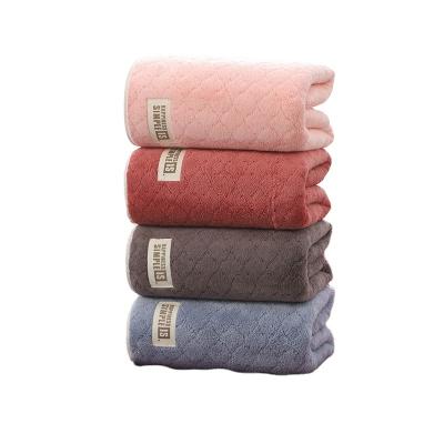 China Sustainable Embossed Coral Velvet Absorbent Bath Towel With Label for sale