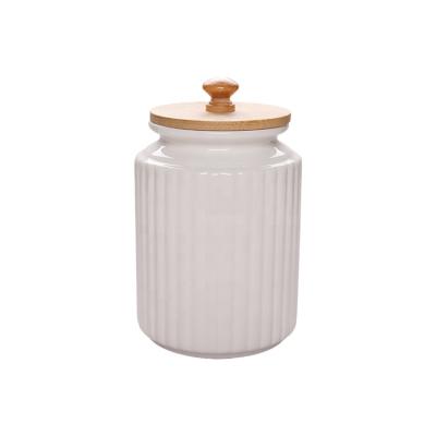 China Stocks Most Popular Glazed White Ceramic Cookie Jar With Lid Bamboo Food Storage Ceramic Jar For Home Kitchen for sale