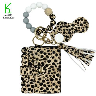 China Custom Anti-lost Silicone Wrist Wallet Card Holder Key Chain Rubber Beaded Leopard Printed Tassel Leather Keychain In Stock for sale