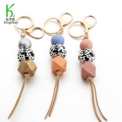 China Leopard Wood Pattern Wooden Bead Tassel Keyholder Holding Down Silicone Beads Wooden Keychain for sale