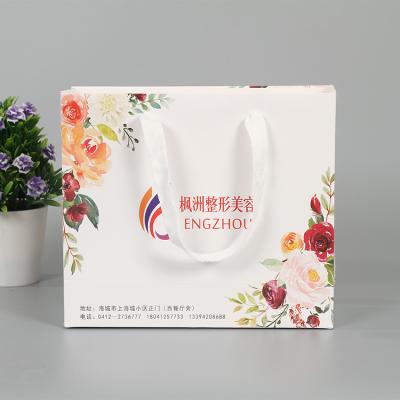 China Recycled Materials Manufacturers Customized Portable Customized Customized Ribbon Shopping Bags Color Logo Apparel Gift Packaging Paper Bags for sale