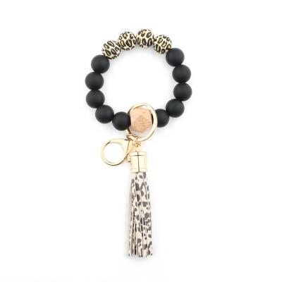 China Bohemia Leather Tassel Bangle Bracelets Keychains Silicone Beads Beech Wood Wrist Beaded Key Ring For Women for sale