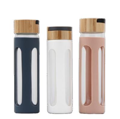 China Disposable Custom Logo 600ml Mini Glass Water Bottle With Bamboo Lid Wholesale for sale