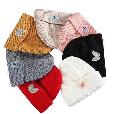 China COMMON 24 Hours Pattern Wholesale Warm Winter Butterfly Embroidery Design Covers Beanie Hats Custom Knitted Unisex for sale