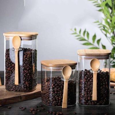 China Freshness Preservation 800ml 1000ml 1200ml glass storage jar with bamboo lid and bamboo spoons for kitchen for sale