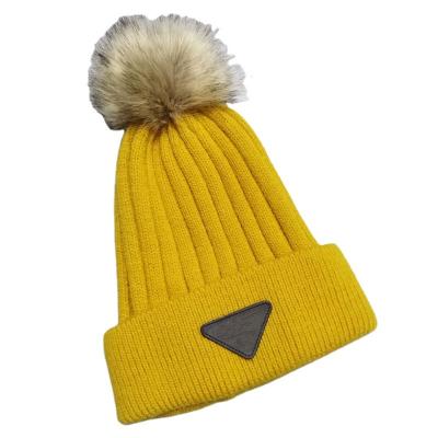 China COMMON Popular Custom Made Warm Knitted Hat For Women Softly 100% Acrylic Beanies Foldable Hat With Pom Pom Design for sale